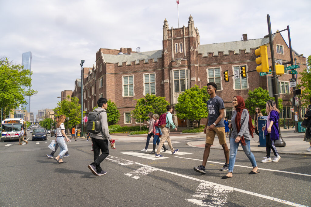 Penn students crossing busy street intersection